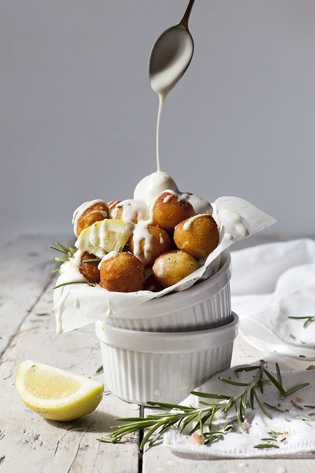 balls of fried potatoes with lemon, rosemary and dripping sauce