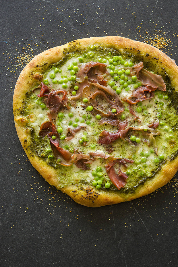 English pea, proscuitto and burrata pizza with pesto sauce.